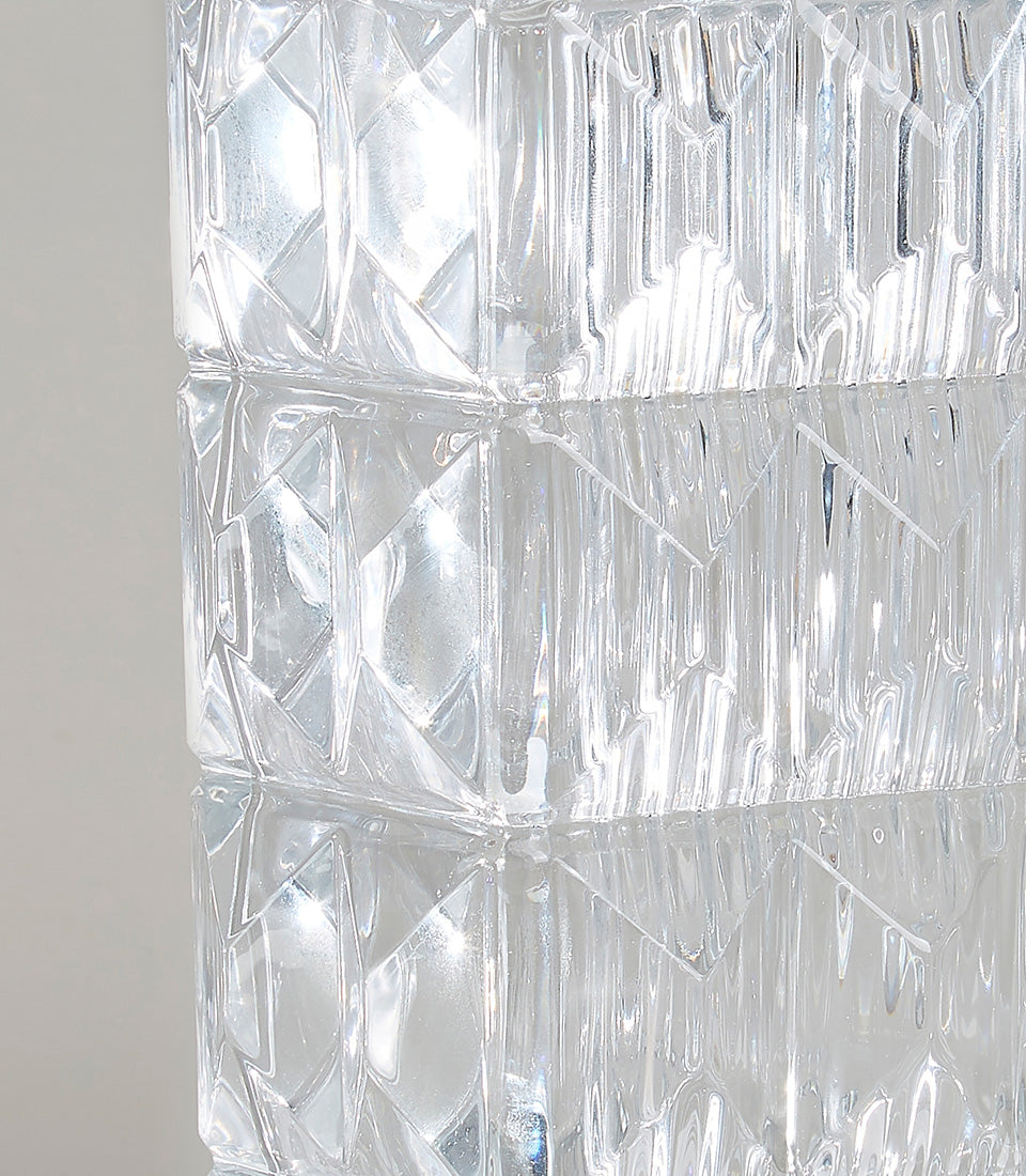 Geometric faceted glass vase with diamond and vertical ridge texture, clear crystal with light refraction