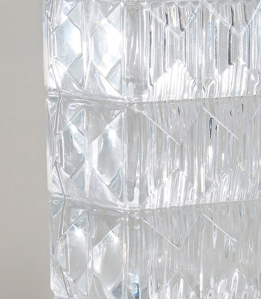 Geometric faceted glass vase with diamond and vertical ridge texture, clear crystal with light refraction