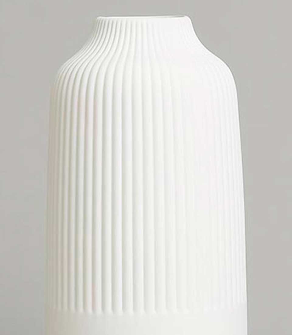 Ribbed white ceramic vase with vertical fluting and tapered opening