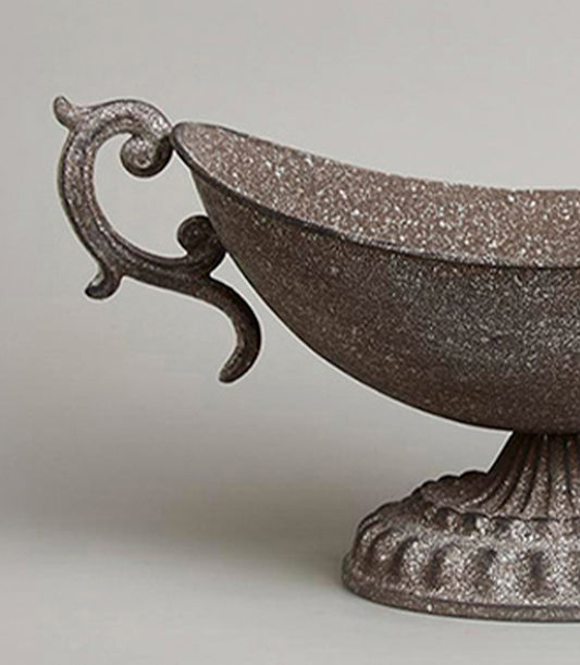 Ornate rustic metal urn vase with scrolled handle and aged bronze finish