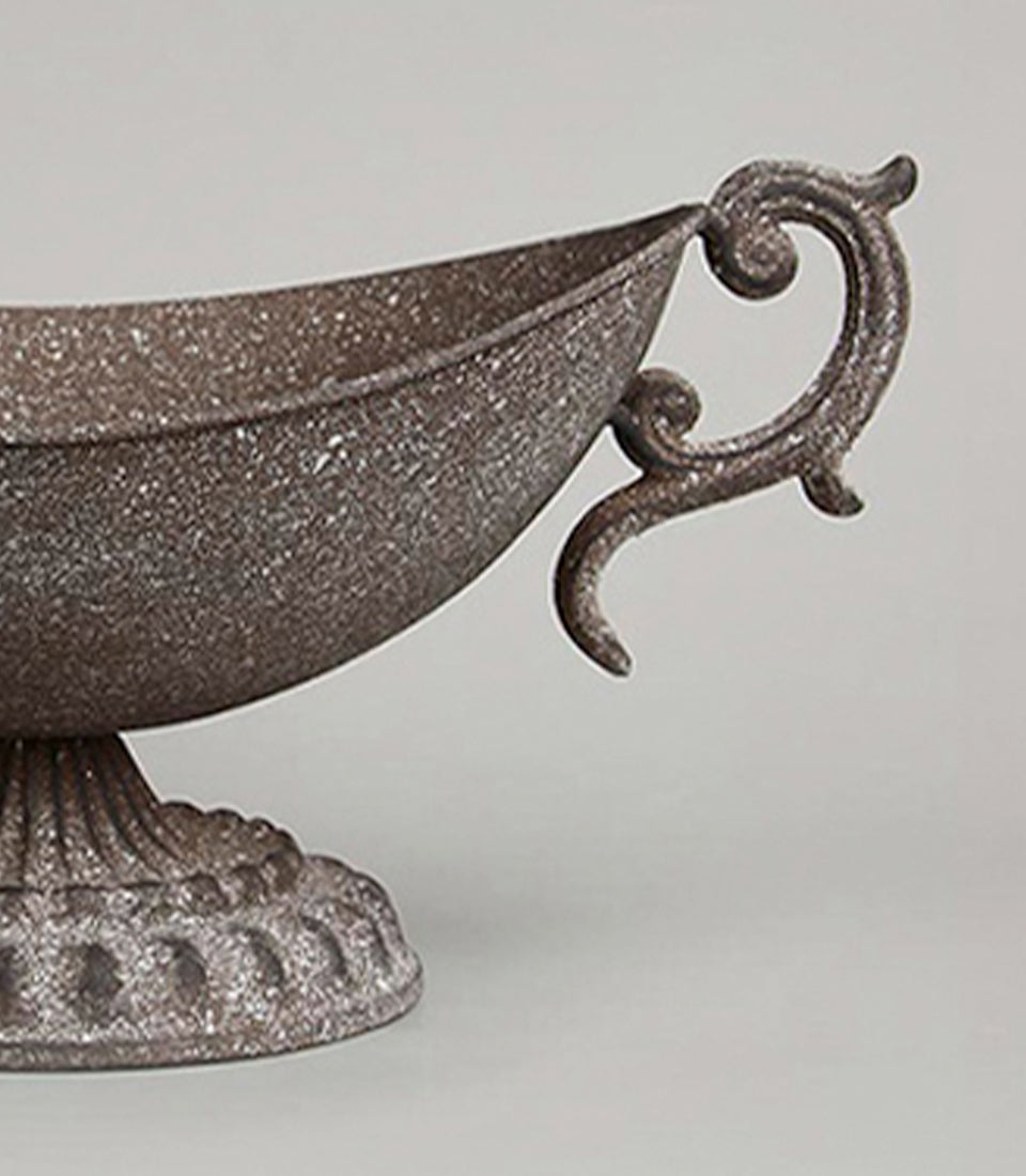 Ornate rustic metal urn vase with distressed brown finish and scrolled handle