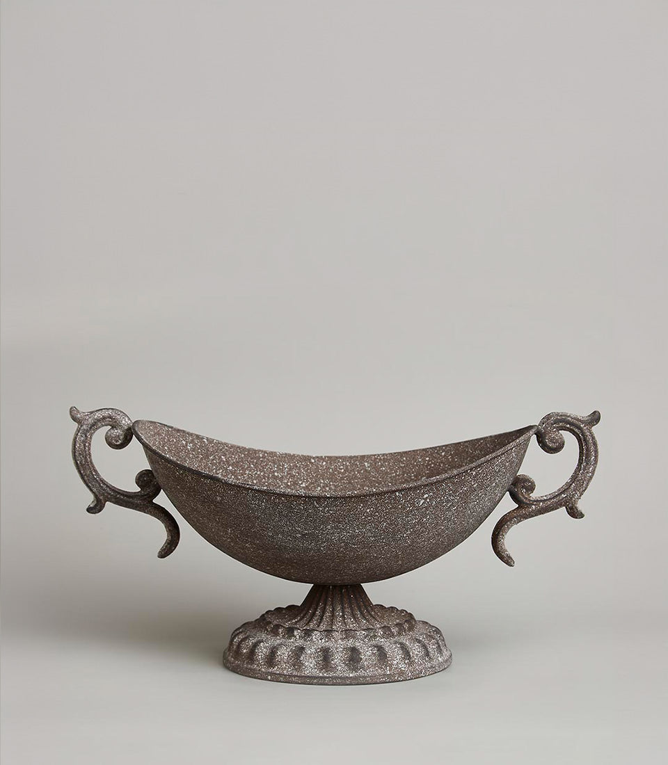 Ornate rustic metal urn vase with scrolled handles and weathered dark finish