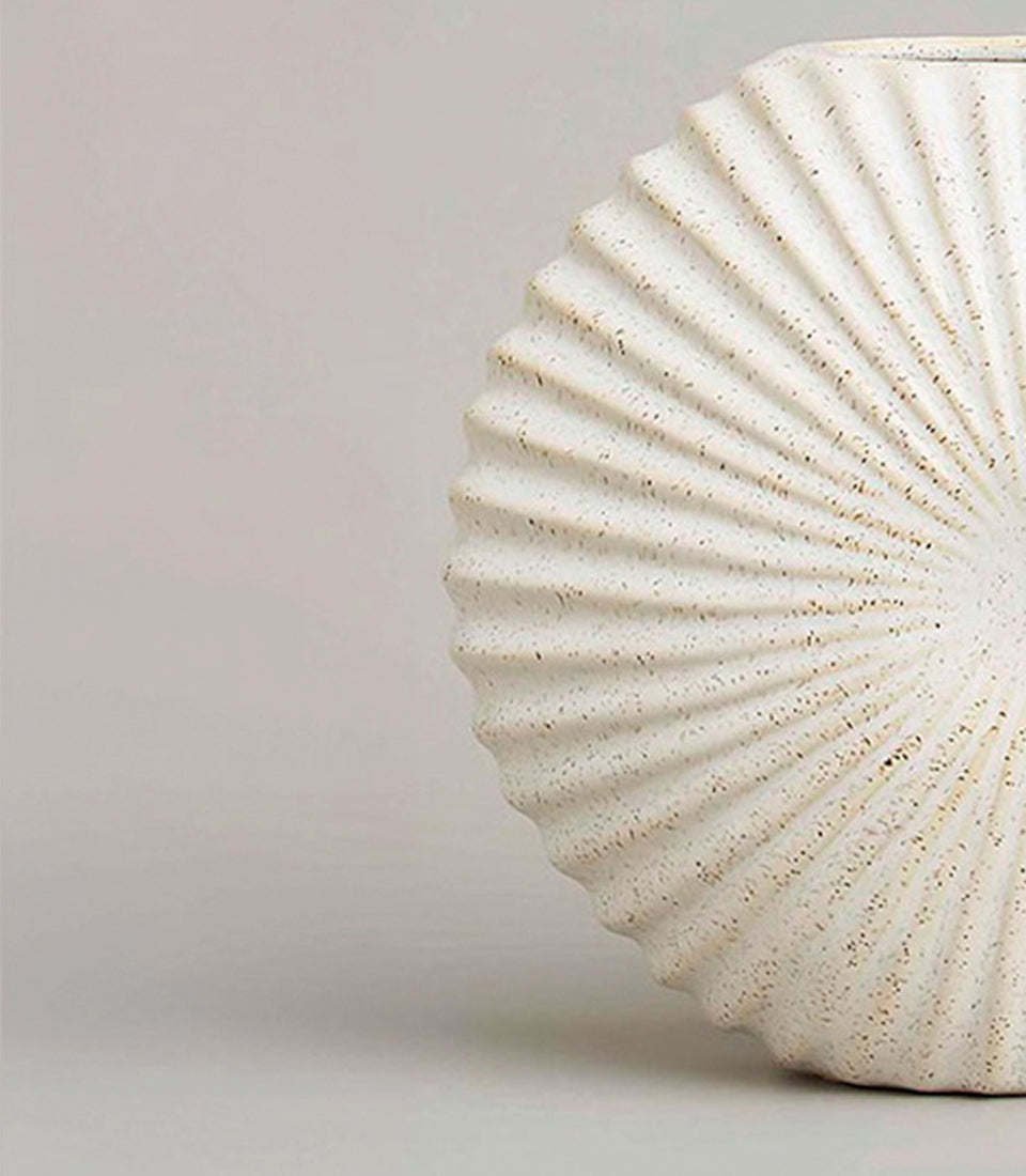 Cream ceramic vase with radial ridged pattern and speckled finish, artisan home décor gift
