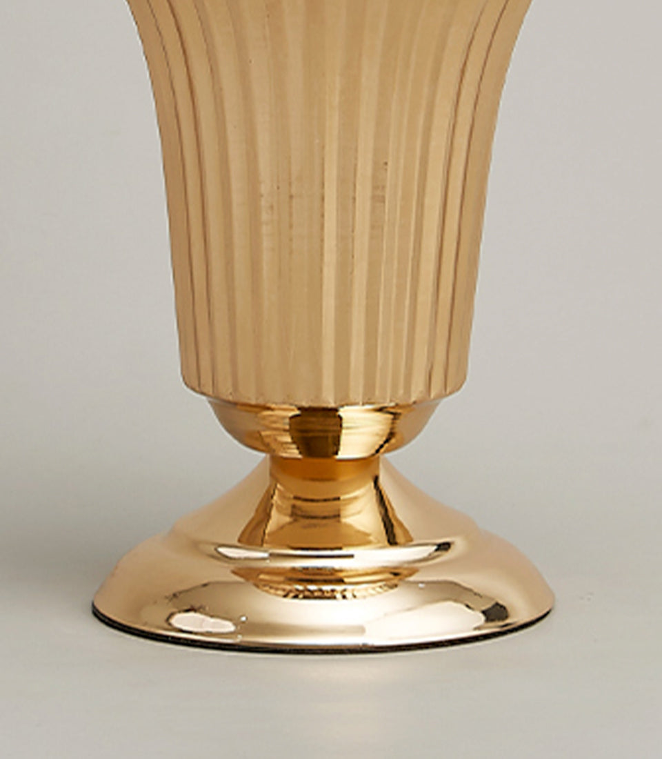 Golden fluted metal vase with polished base and elegant vertical ridge texture