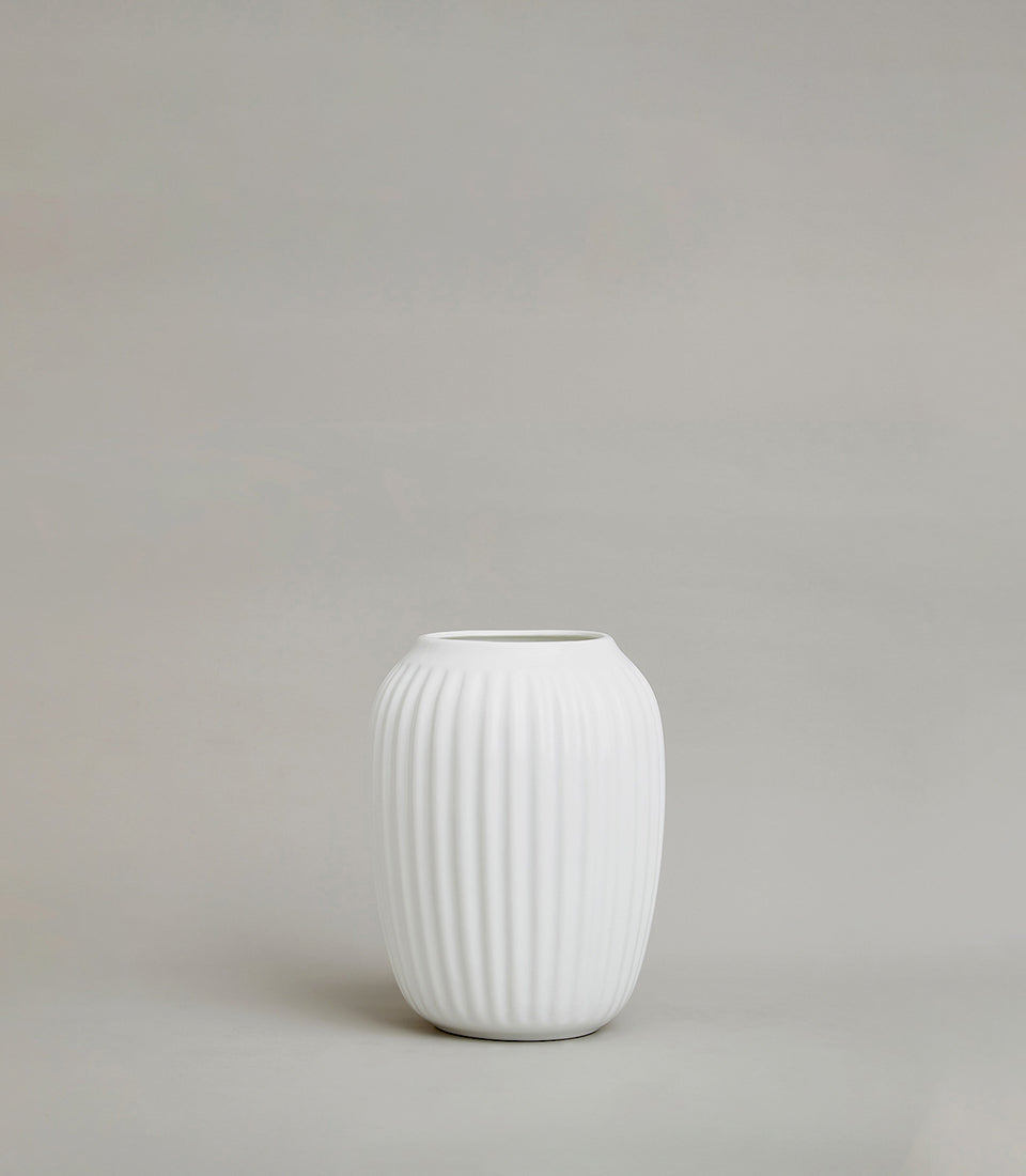 Minimalist white ribbed ceramic vase with matte finish and tapered oval shape