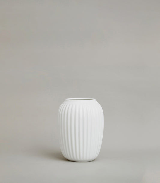Minimalist white ribbed ceramic vase with matte finish and tapered oval shape