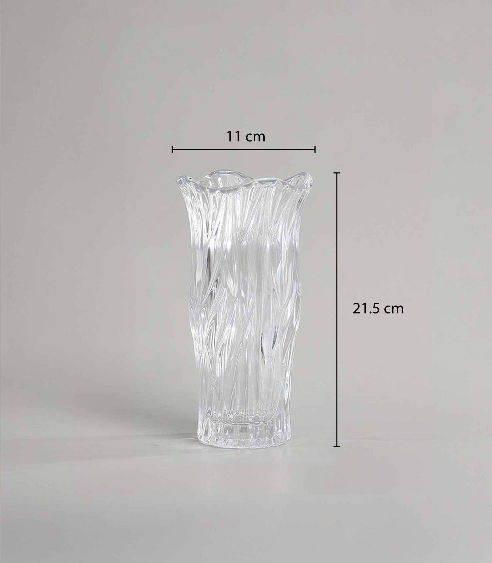 Clear glass vase with textured wave design and scalloped rim for fresh flowers or decorative display
