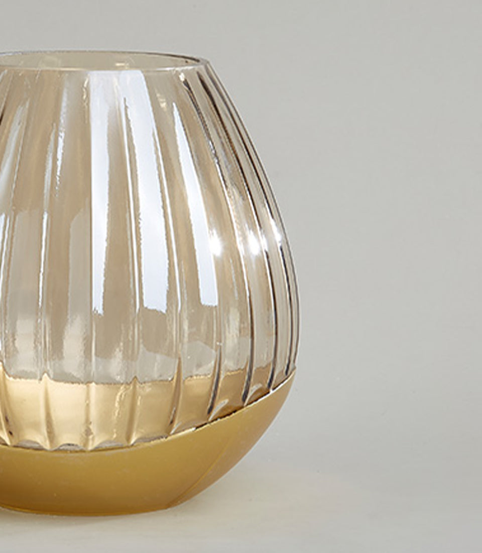 Translucent amber ribbed glass vase with metallic gold base