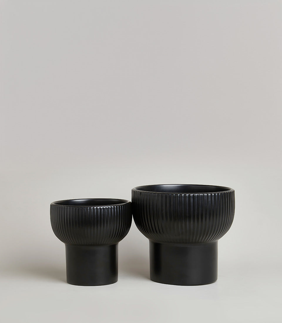 Black ceramic vases with ribbed texture detail, modern minimalist design in two sizes