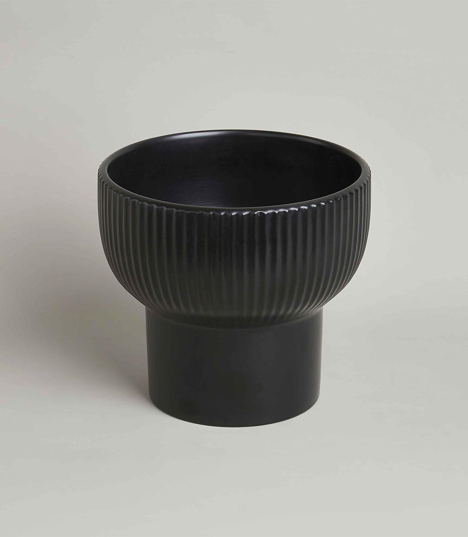 Matte black ceramic vase with fluted bowl and pedestal base for contemporary gifting