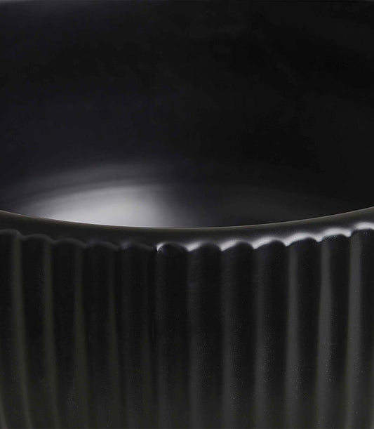 Black fluted ceramic vase with matte finish and ribbed texture detail
