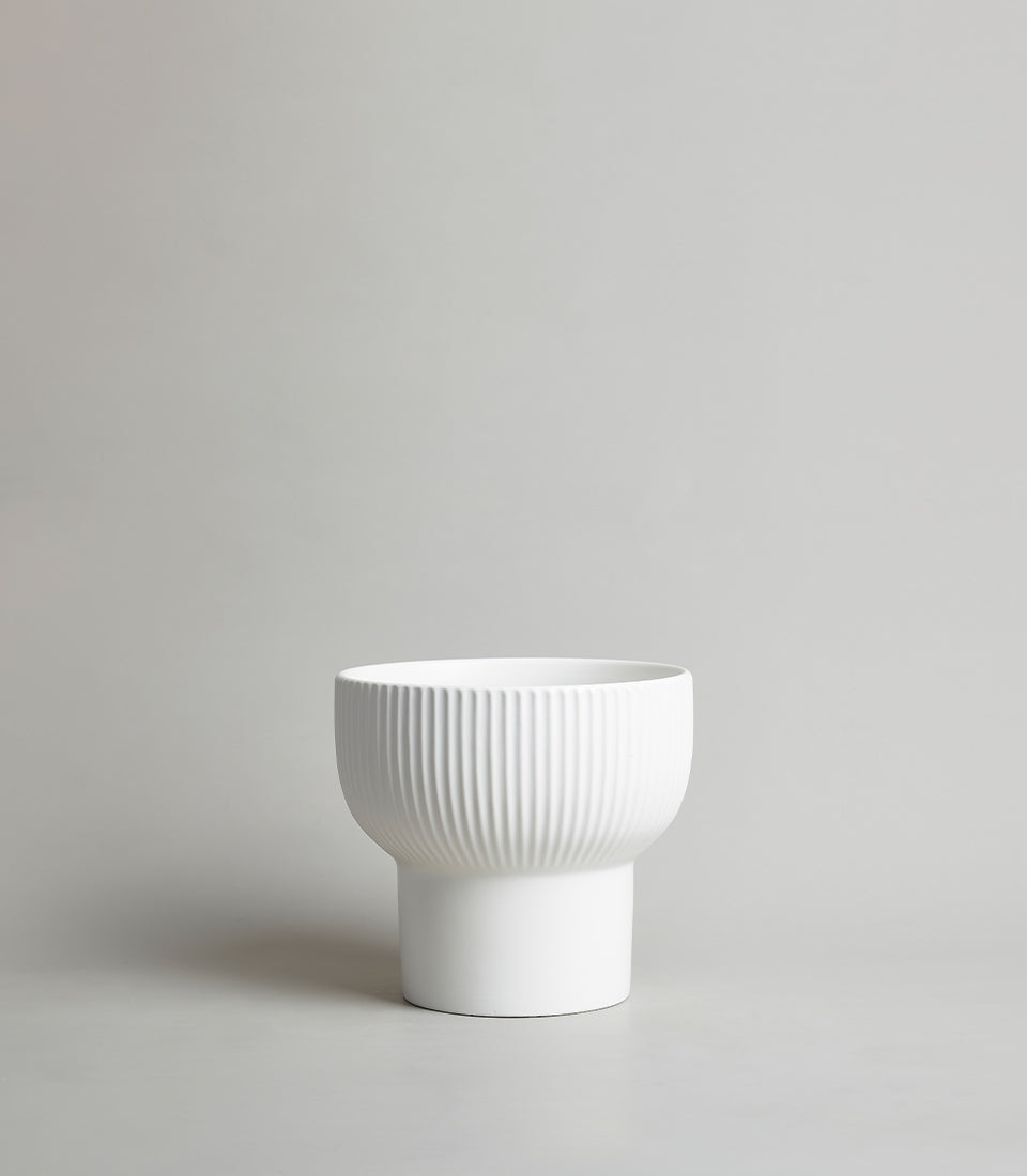 White ribbed ceramic vase with smooth cylindrical base, modern minimalist design