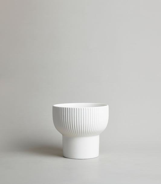 White ribbed ceramic vase with smooth cylindrical base, modern minimalist design