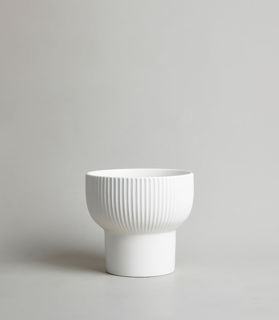 White ceramic vase with ribbed texture design, two-tiered modern shape