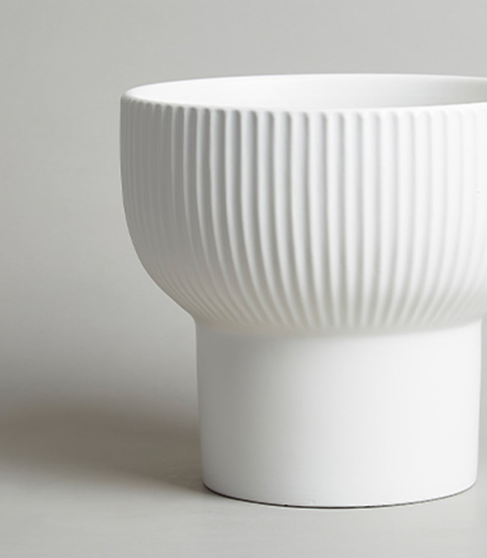 White ceramic vase with vertical fluted texture, modern minimalist design for contemporary home decor