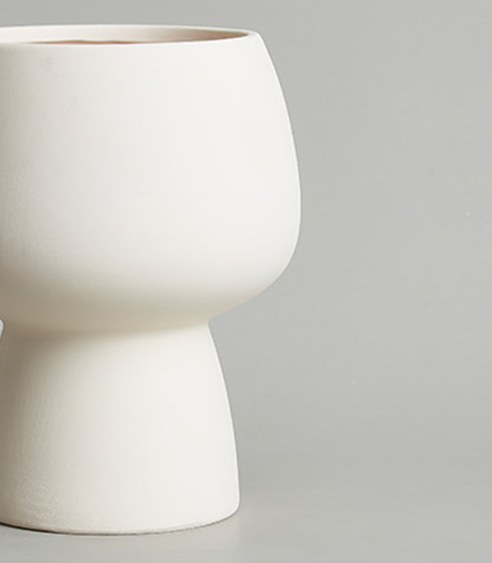 Modern off-white ceramic planter vase with tapered cylindrical base and matte finish