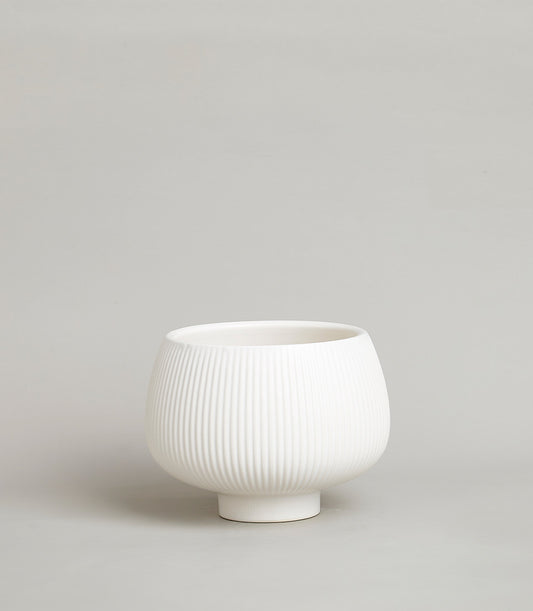 White ceramic fluted vase with pedestal base, minimalist modern design for home decor or gifting