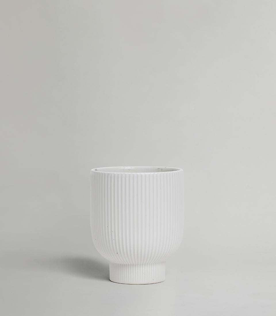 Modern white ribbed ceramic vase with matte finish and tapered base