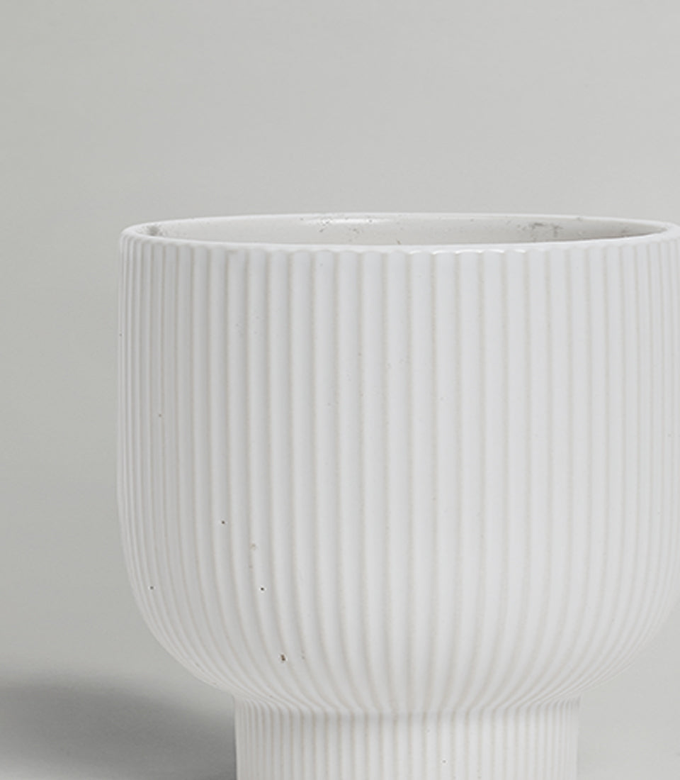 Modern white ribbed ceramic vase with vertical fluting and matte finish
