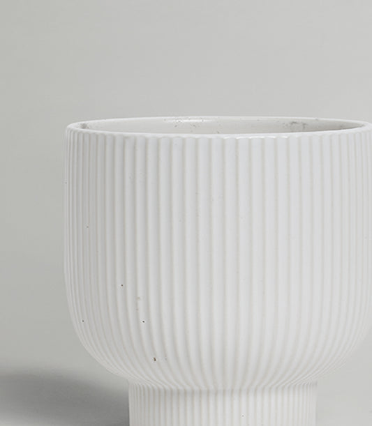Modern white ribbed ceramic vase with vertical fluting and matte finish