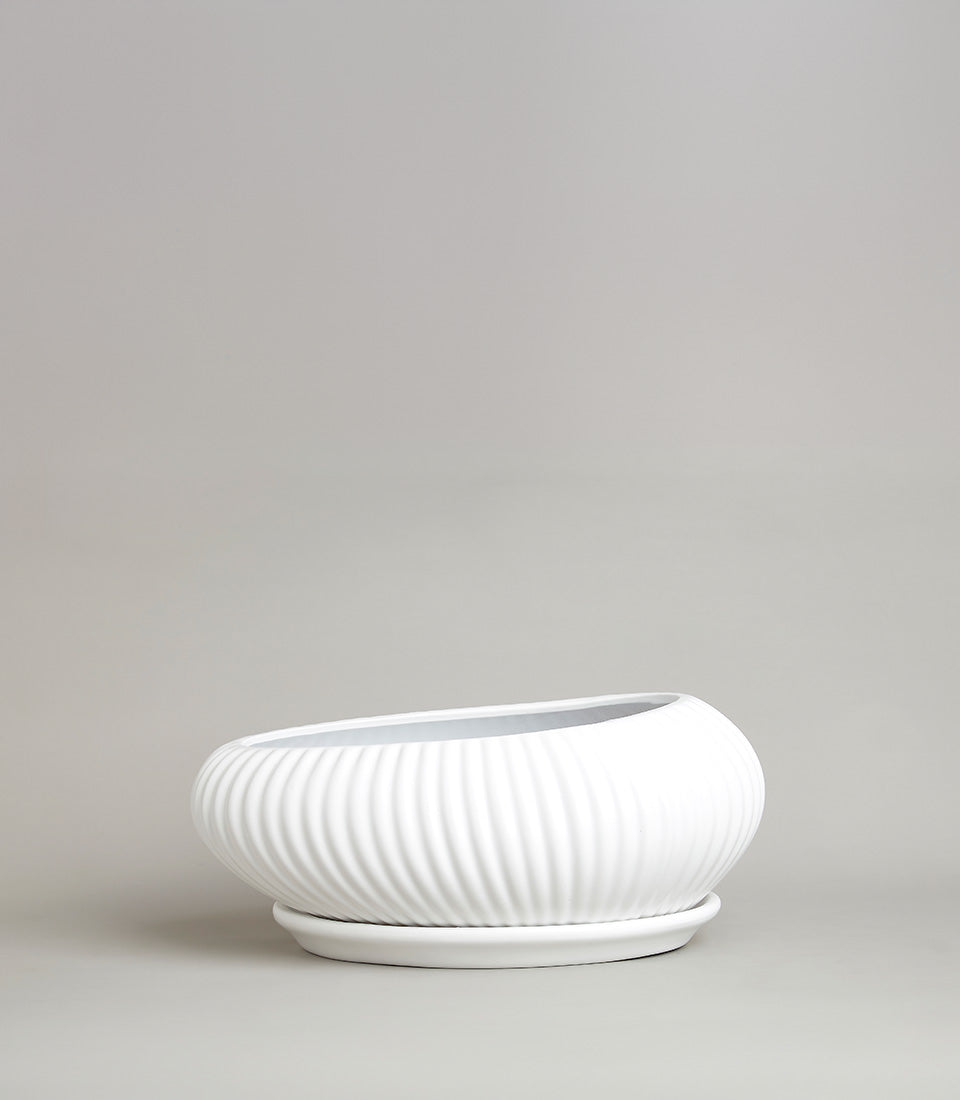 White ceramic planter with wavy ridges and matching saucer for fresh flowers or greenery