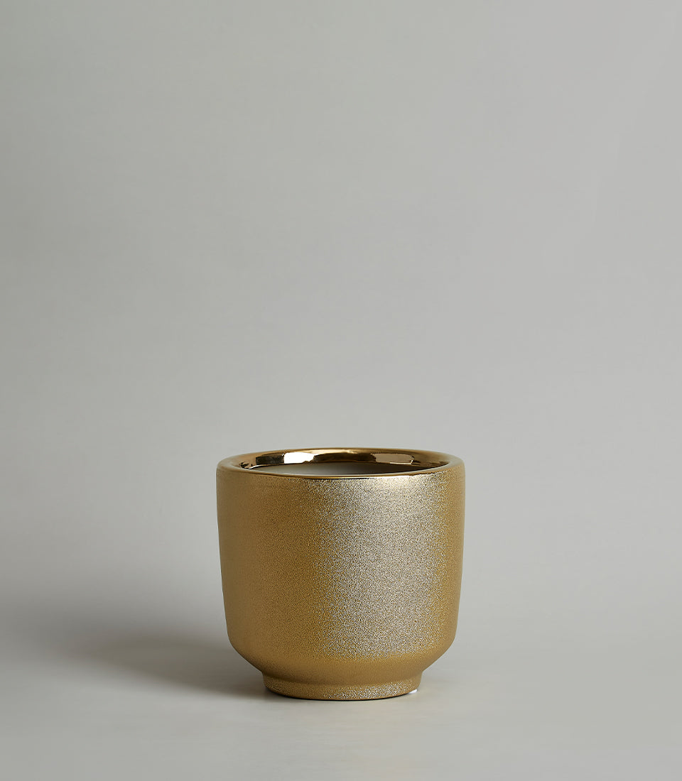 Shimmering gold ceramic vase with textured matte finish and polished rim