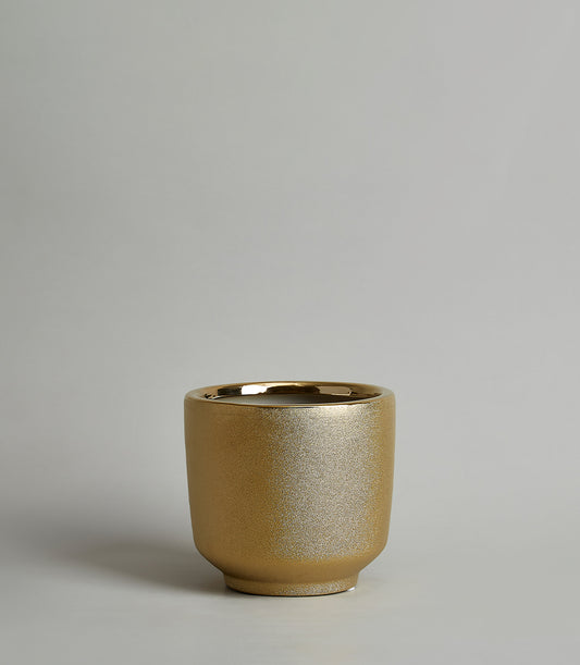 Shimmering gold ceramic vase with textured matte finish and polished rim