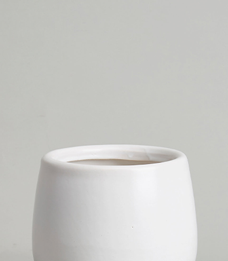 Minimalist white ceramic cylindrical vase with matte finish for fresh flowers or home décor