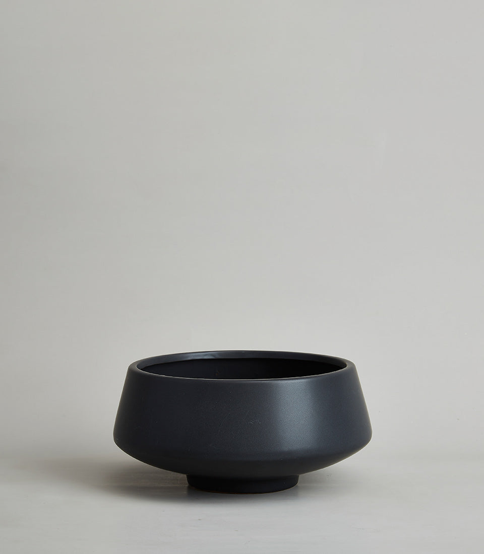 Matte black ceramic vase with modern minimalist design and tapered silhouette