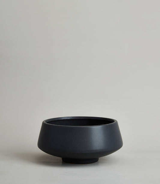 Matte black ceramic vase with modern minimalist design and tapered silhouette
