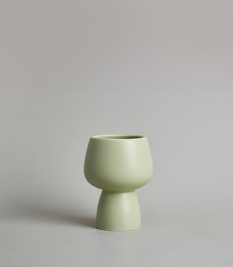 Modern light green ceramic chalice vase with matte finish and sculptural design