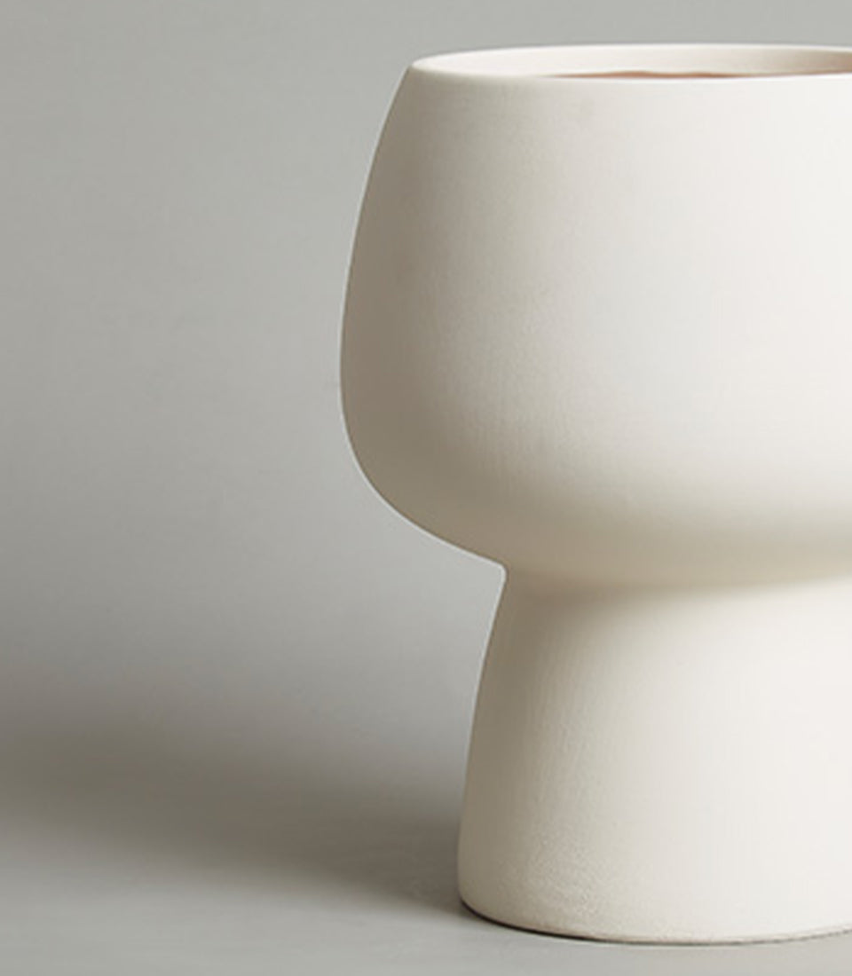 Modern cream ceramic chalice vase with sculptural tapered silhouette, perfect for fresh flowers or home decor