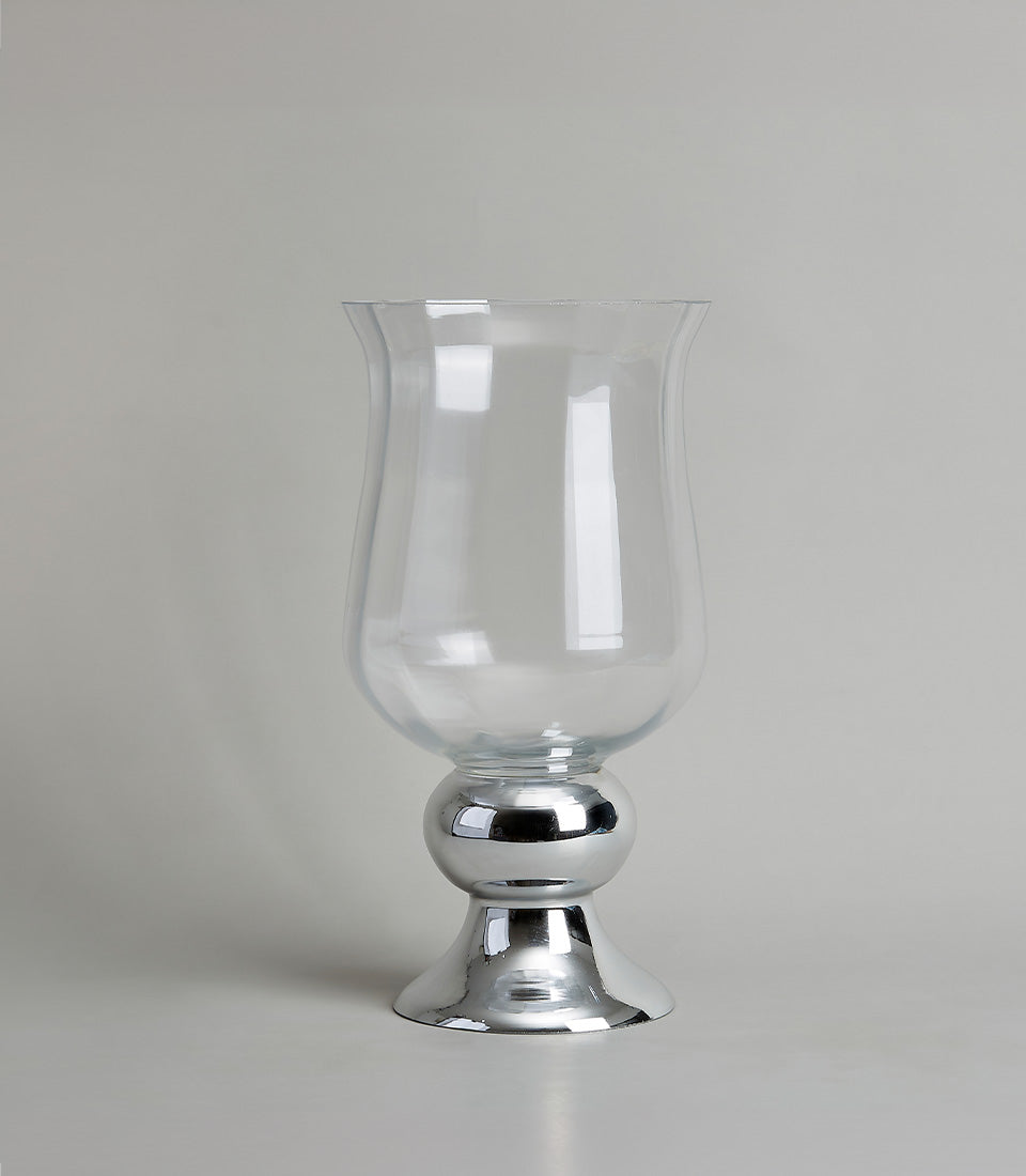 Clear glass vase with a tulip shape and polished chrome base, awaiting a premium flower arrangement from Flowers by Basketeer.