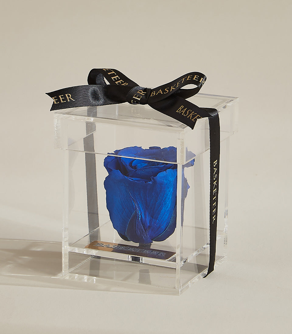 Vibrant blue preserved rose in elegant acrylic box with gold-lettered plaque and black satin ribbon