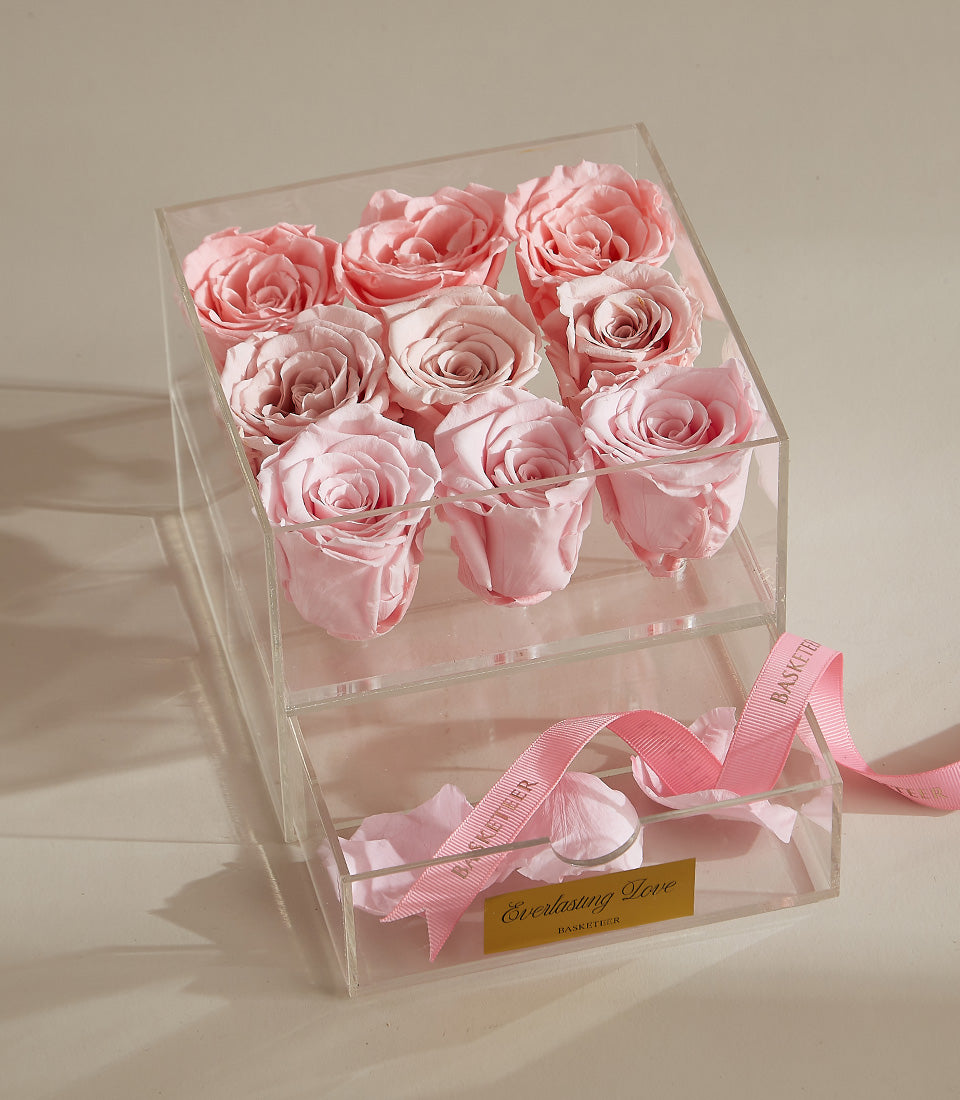 Preserved pink roses in acrylic box with rose petals and ribbon for Valentine's Day