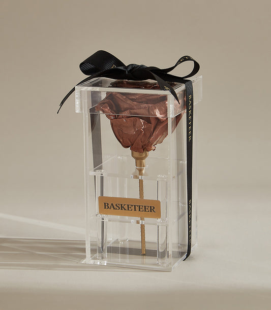 Preserved brown rose in clear acrylic box with golden stem and black grosgrain ribbon bow
