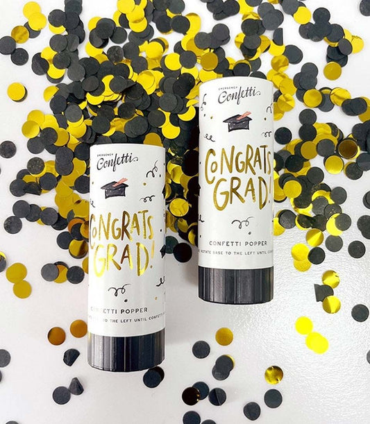 Black and gold confetti cannons from Charlotte Bakery! Perfect to celebrate a custom cake order in Bangkok. "Congrats Grad!" adorns the label.