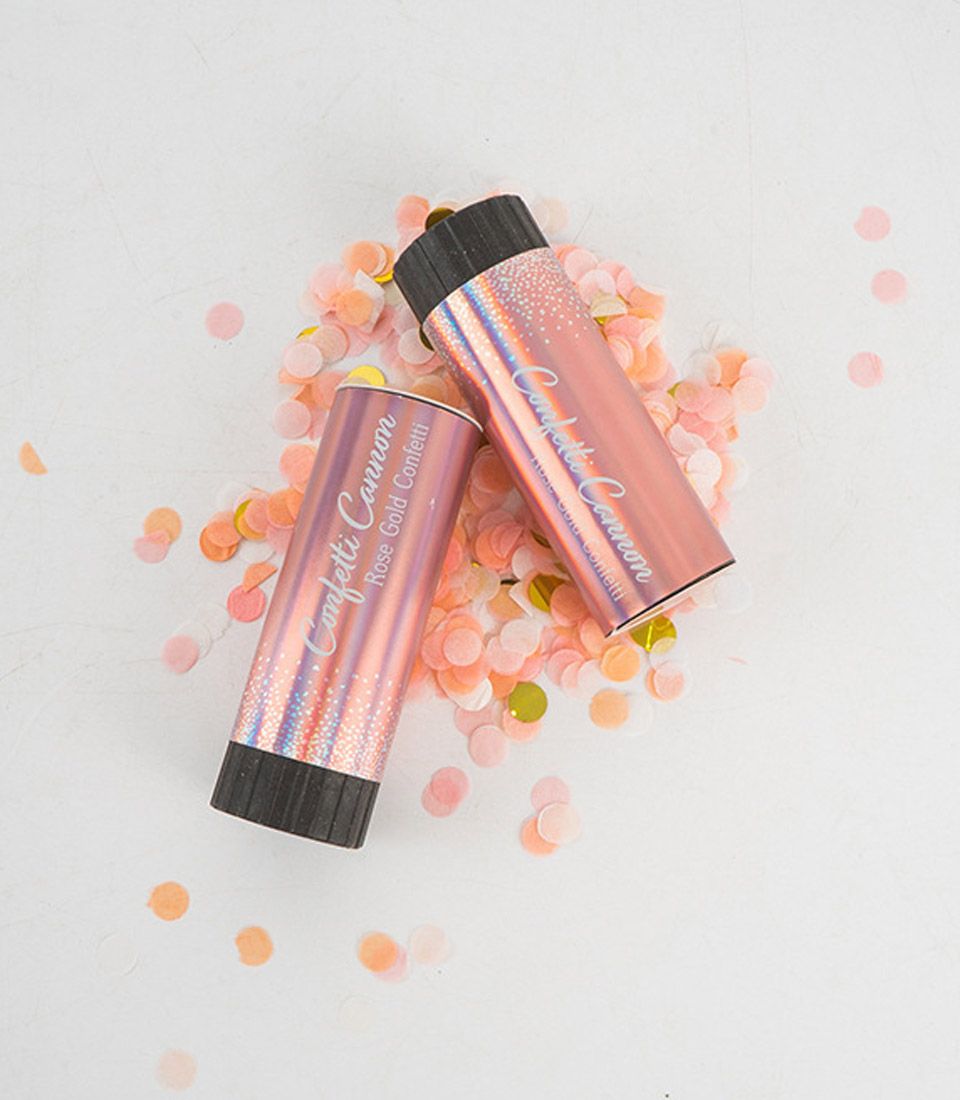 Rose gold confetti cannon with holographic finish and scattered rose gold confetti for celebration cakes