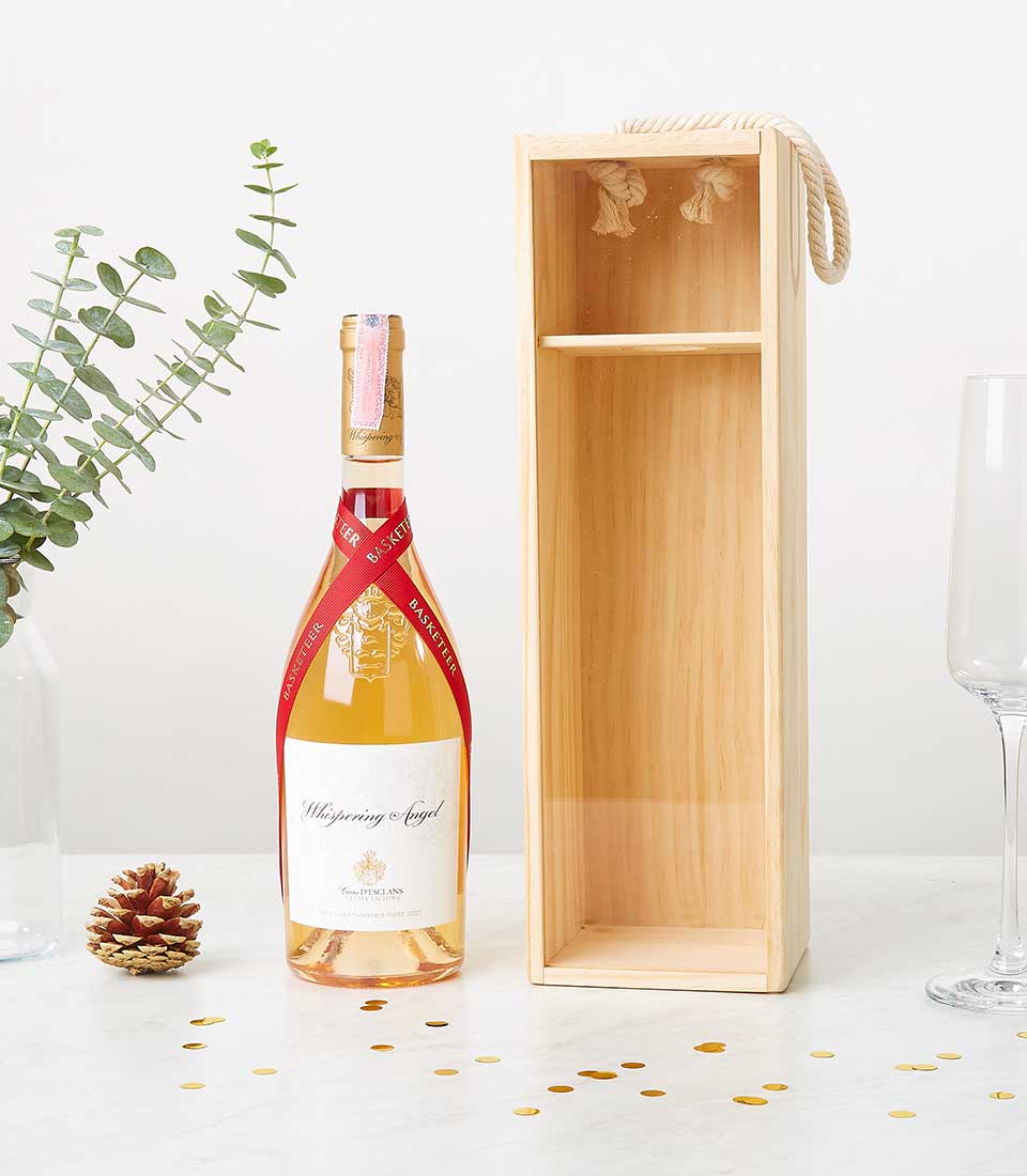 Whispering Angel rosé wine with wooden gift box, gold confetti, and festive presentation