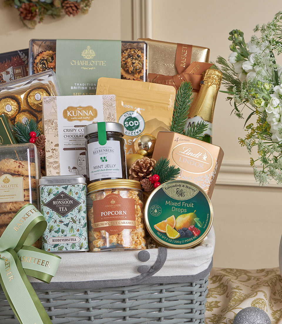 Premium gold luxury gift basket with gourmet treats, wine, chocolates, and festive accents for New Year celebrations