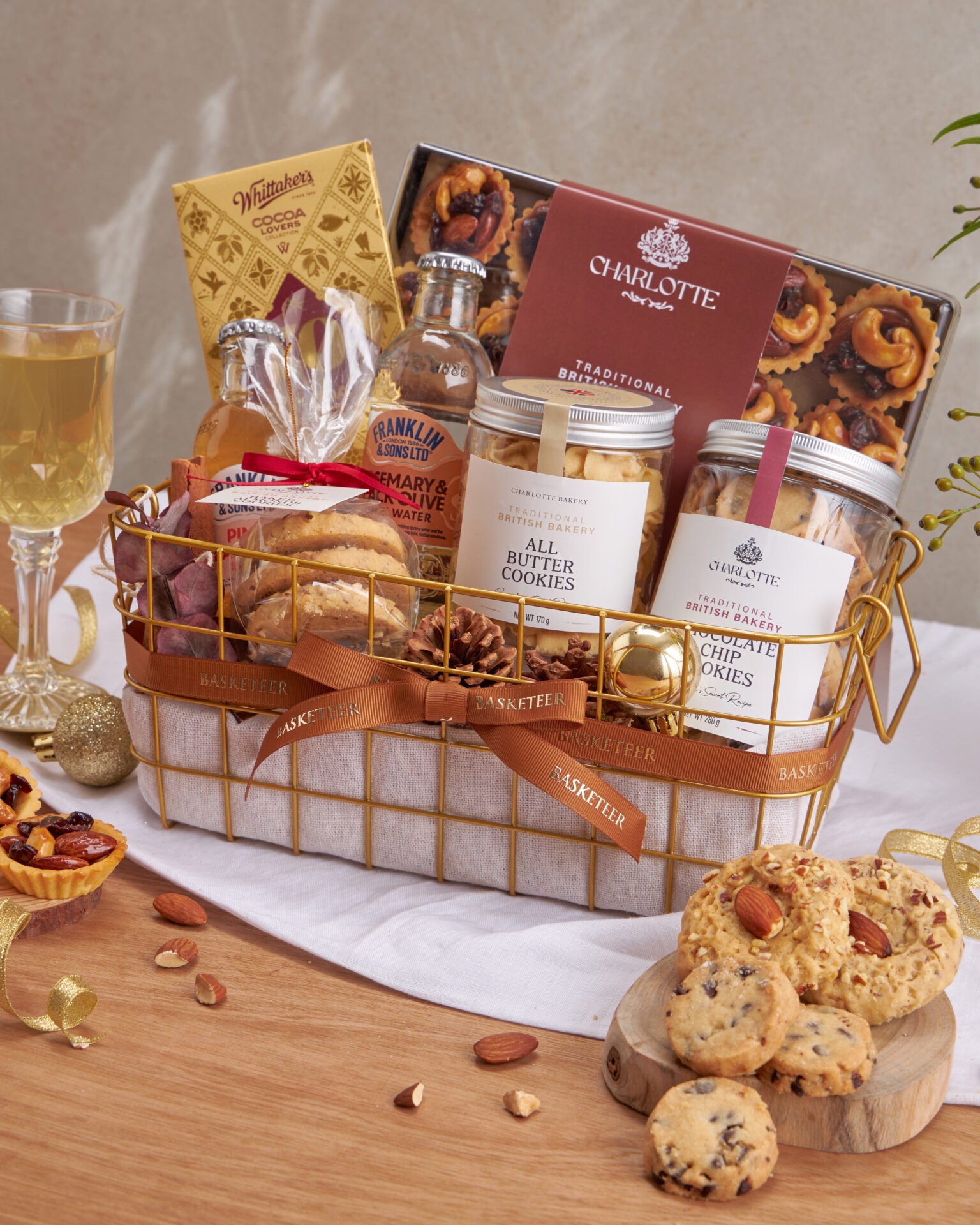 Gold wire gift basket with Charlotte Bakery British cookies, Whittaker's chocolates, artisan tarts, and gourmet beverages