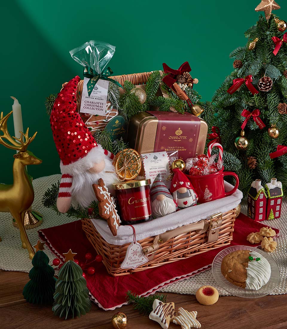 Festive Christmas gift basket with red wicker, gnome plush, holiday cookies, candle and festive mugs