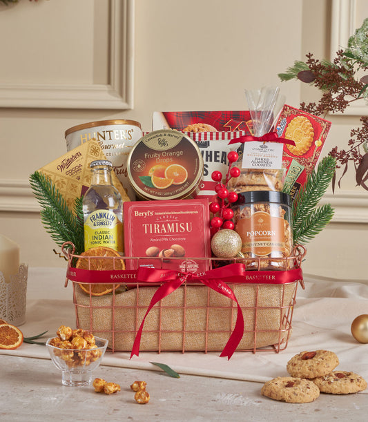 Luxury tiramisu truffle gift basket with rose gold wire design, red ribbon, gourmet chocolate, cookies, and festive greenery