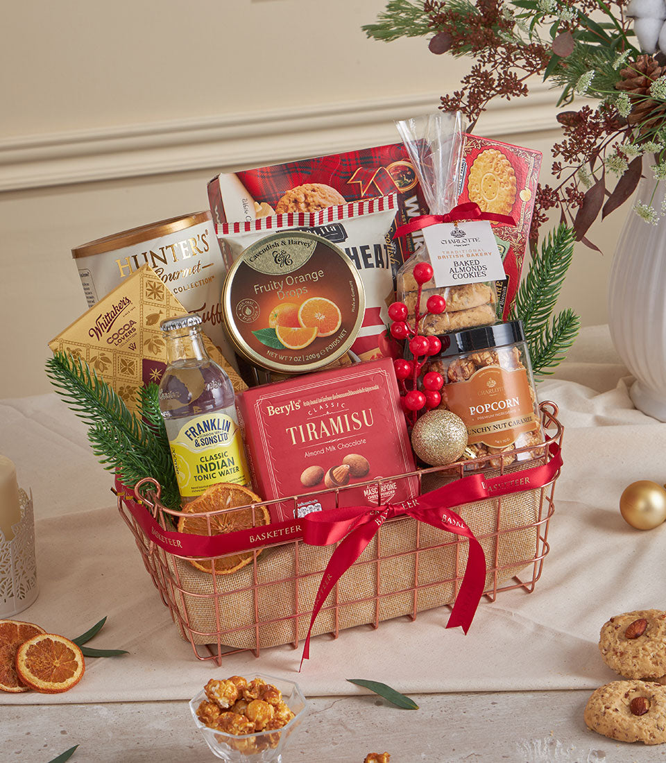 Rose gold wire gift basket with tiramisu chocolate, gourmet treats, and festive red ribbon for New Year celebrations
