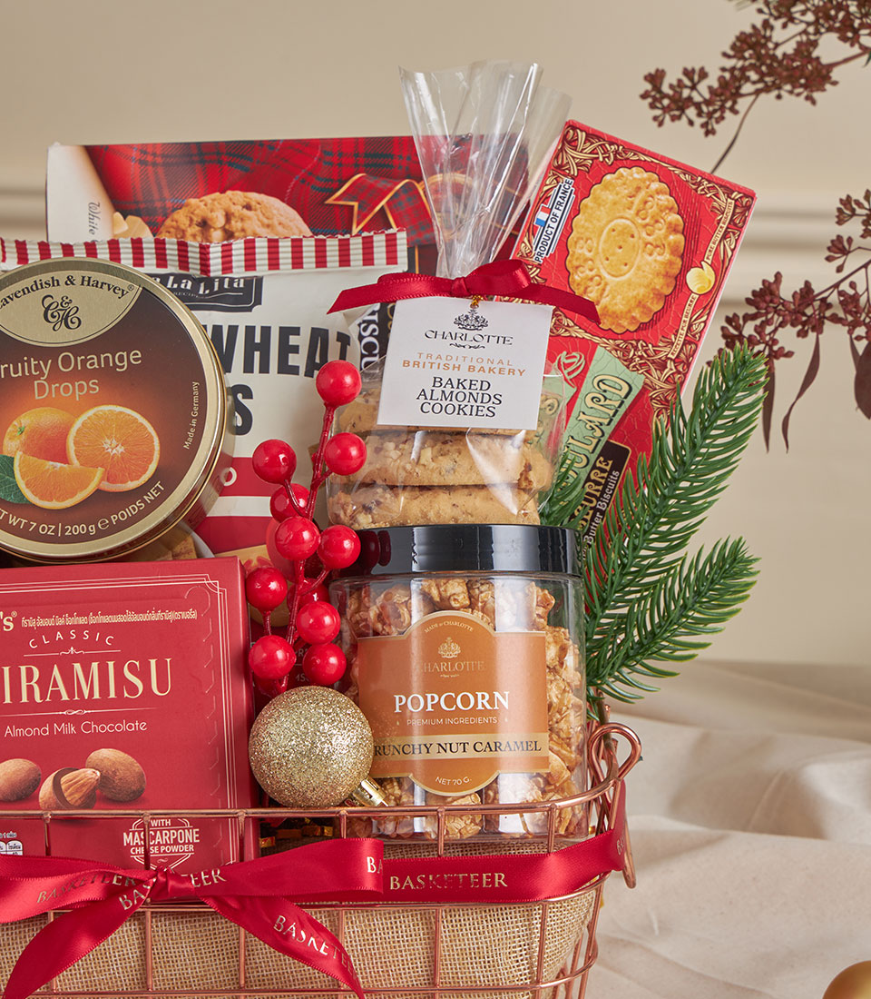 Festive gourmet gift basket with tiramisu chocolate, almond cookies, and caramel popcorn, copper wire design with holiday
