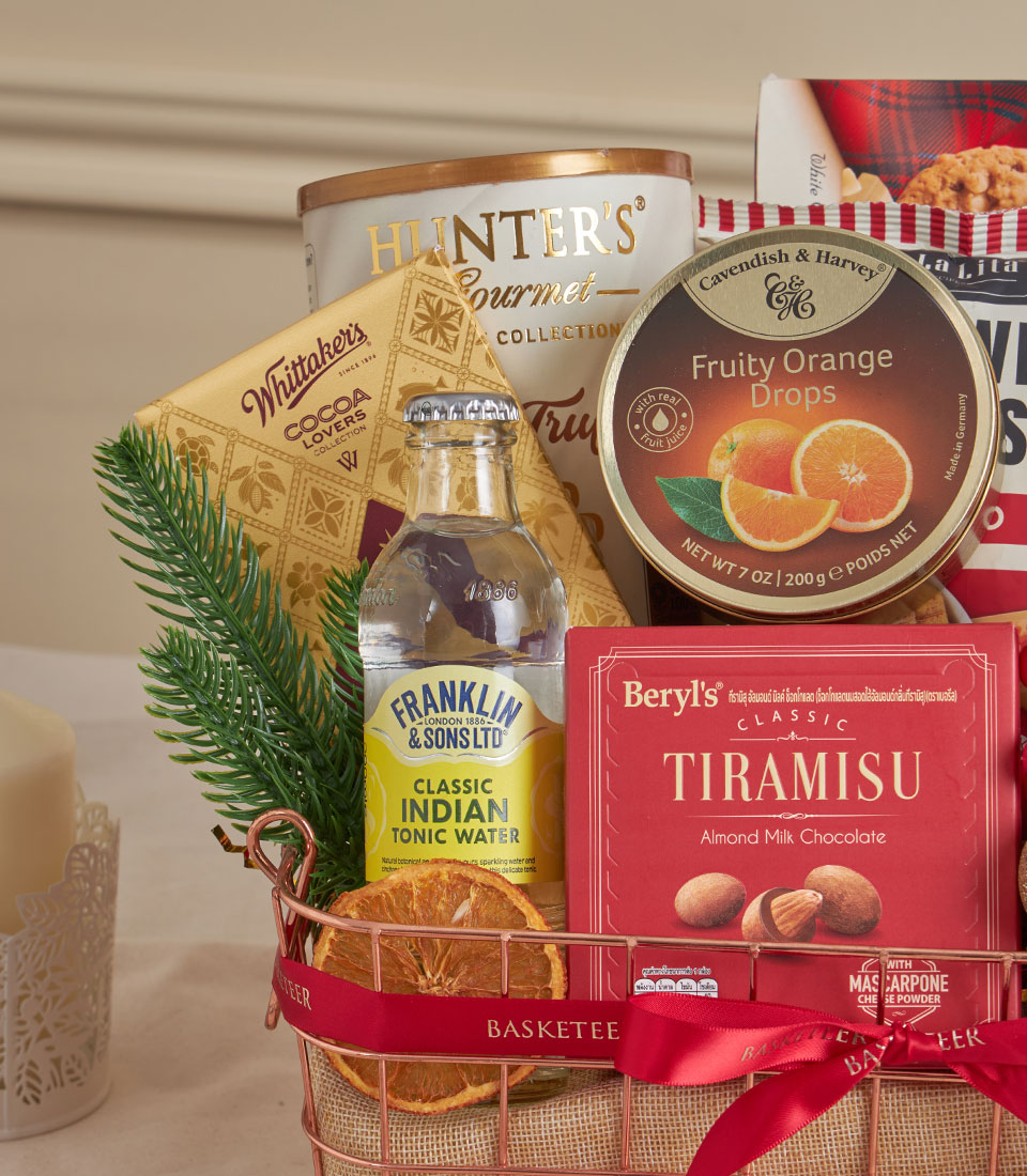 Rose gold wire basket with tiramisu chocolate, gourmet snacks, and premium treats for New Year gifting