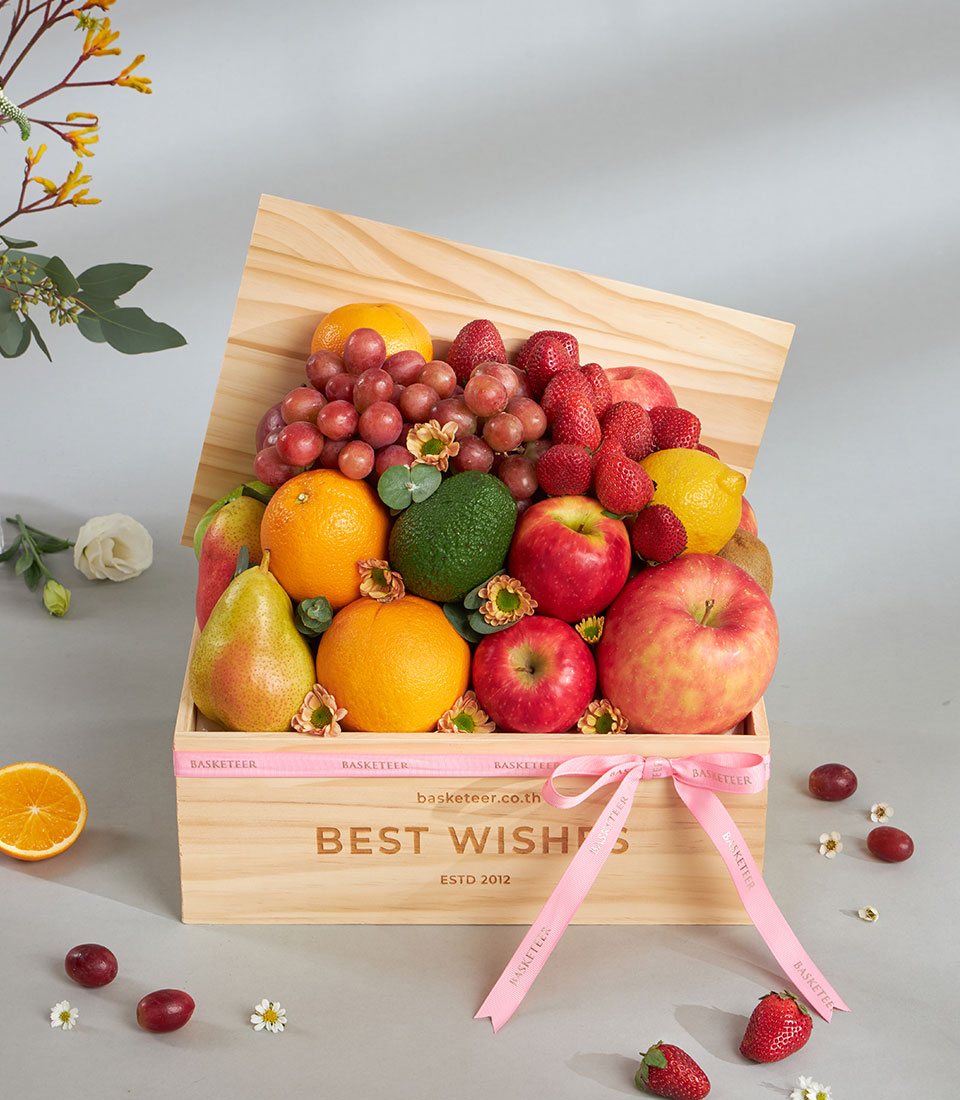 Premium fresh fruit wooden gift box with strawberries, grapes, and citrus, tied with pink Basketeer ribbon