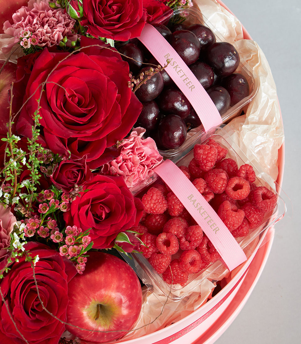 Luxury red fruit and floral round box with roses, cherries, raspberries, and apple for birthday gifting