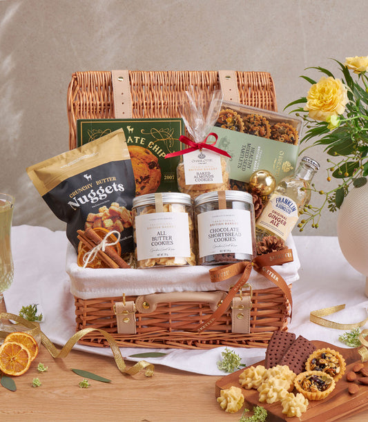 Woven wicker luxury gift hamper filled with artisan cookies, butter nuggets, shortbread, and gourmet treats with gold accents
