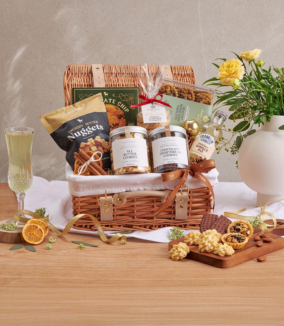 Wicker gift hamper with premium British butter cookies, chocolate shortbread, almond bakes, and gourmet treats in cream